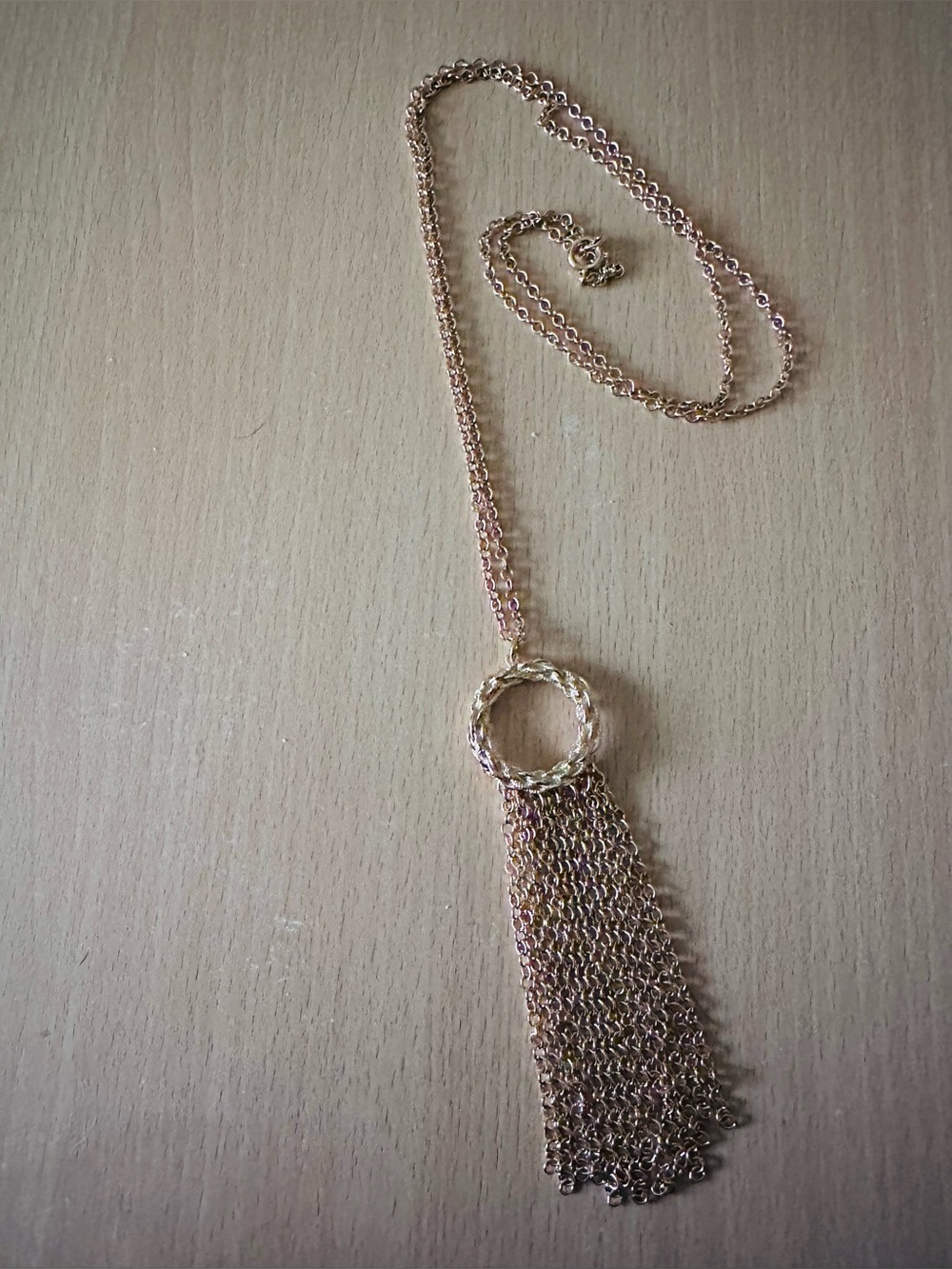 Gold tone necklace unsigned measures 23 inches to bottom of tassels